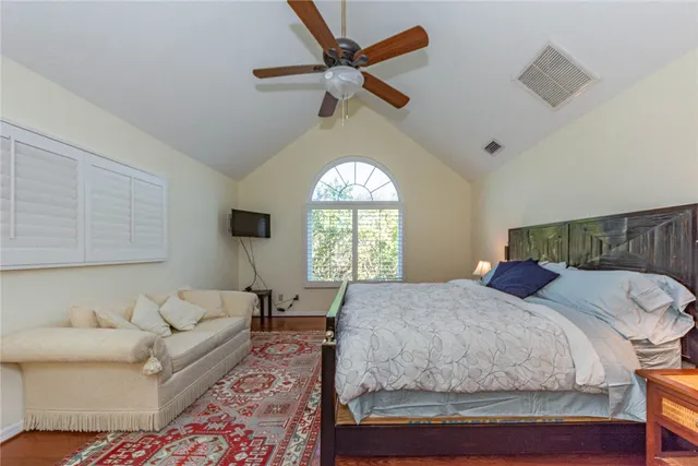 a bedroom with a large bed and a large window