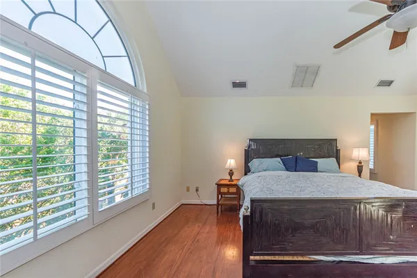 a bedroom with a bed and a large window