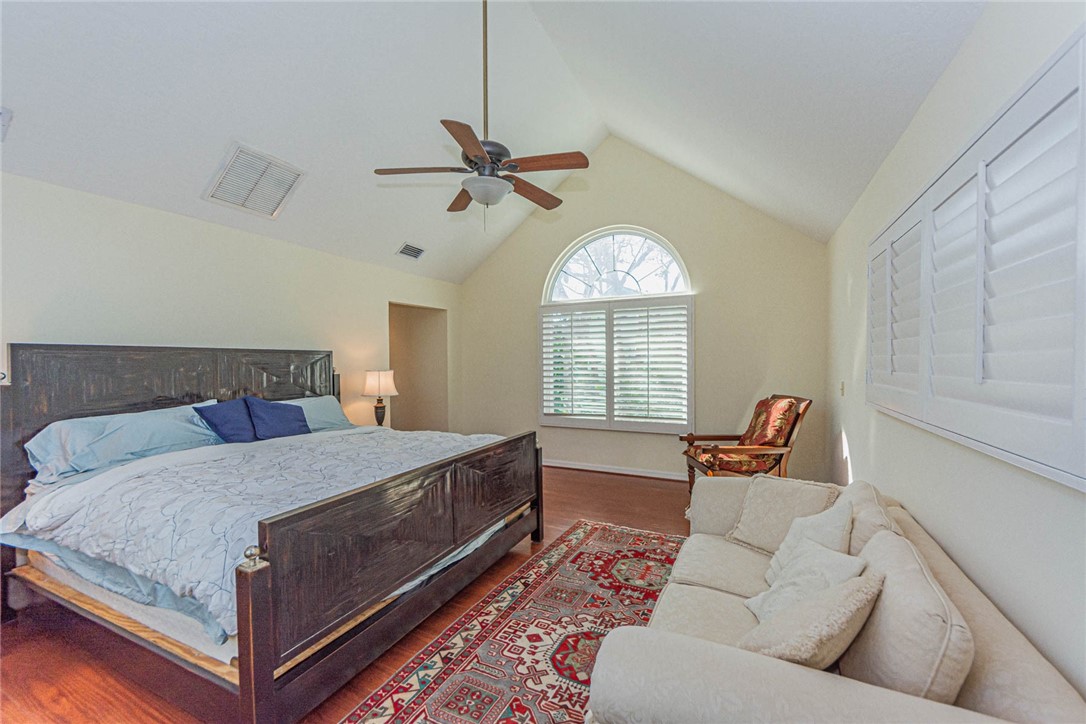 1850 East Sandpiper Road Vero Beach, FL 32963 - Photo 19 of 36 a bed room with a bed and a chandelier