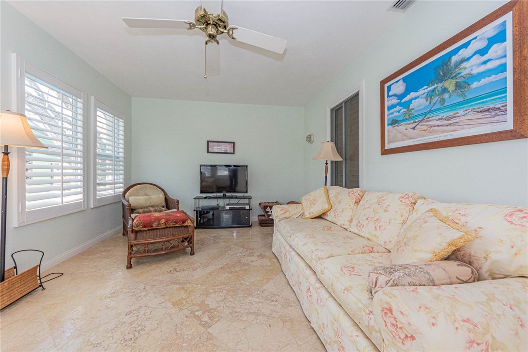 1850 East Sandpiper Road Vero Beach, FL 32963 - Photo 23 of 36 a living room with furniture a couch and a chandelier