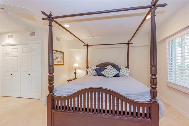 a bedroom with a bed window and a table