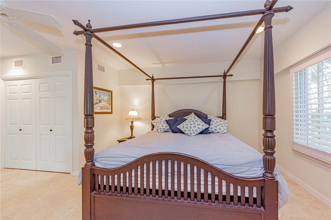 1850 East Sandpiper Road Vero Beach, FL 32963 - Photo 27 of 36 a bedroom with a bed window and a table