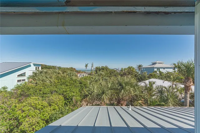 a view of a room with wooden floor and bench