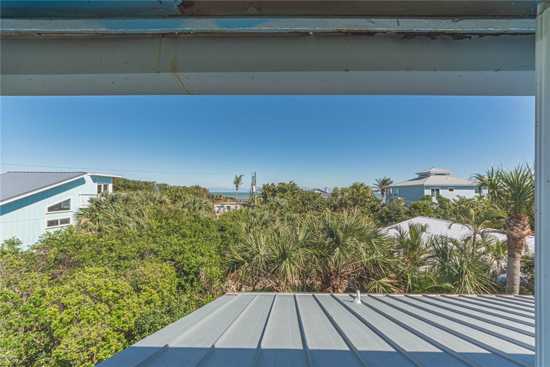 1850 East Sandpiper Road Vero Beach, FL 32963 - Photo 31 of 36 a view of a room with wooden floor and bench