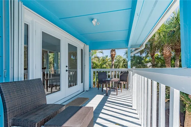 a view of balcony with wooden floor and outdoor seating