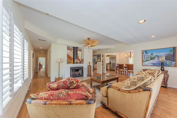 a living room with furniture fireplace and large windows