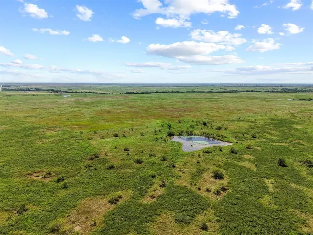 a view of a field with an ocean