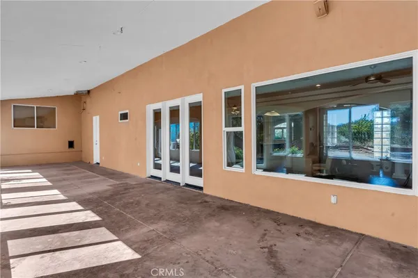 a view of backyard with large windows