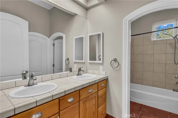a kitchen with stainless steel appliances granite countertop a sink window and cabinets