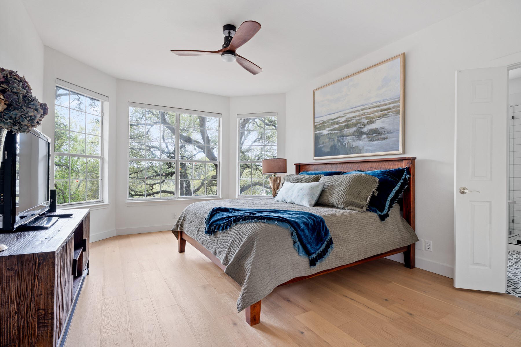 102 Hurst Creek Road Lakeway, TX 78734 - Photo 17 of 29 a spacious bedroom with a large bed and a window