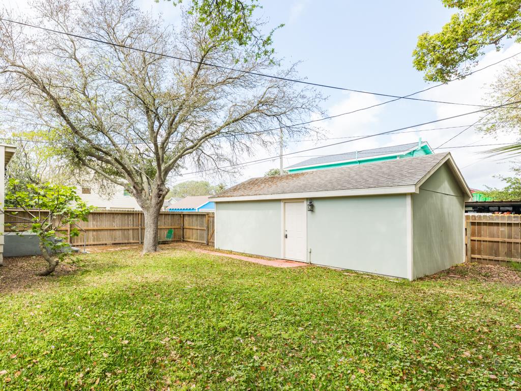 4528 Avenue R 1/2 Galveston, TX 77551 - Photo 9 of 22 a view of a house with a yard and garage