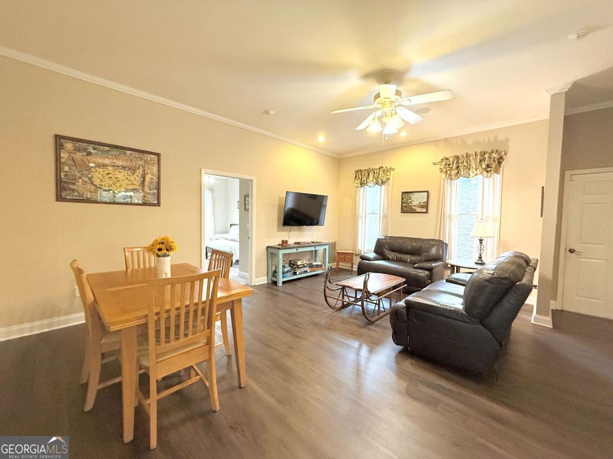 2415 Elko Road Elko, GA 31025 - Photo 15 of 85 a living room with furniture a flat screen tv and wooden floor
