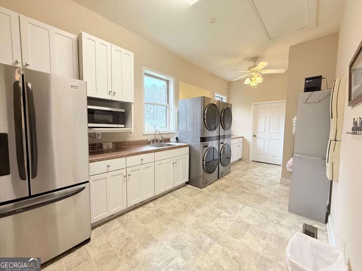 2415 Elko Road Elko, GA 31025 - Photo 45 of 85 a kitchen with stainless steel appliances a refrigerator sink and cabinets