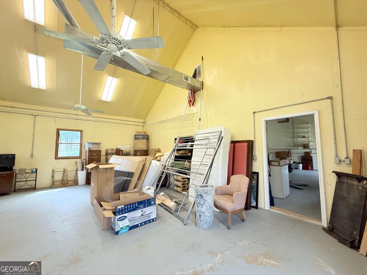 2415 Elko Road Elko, GA 31025 - Photo 60 of 85 a living room with furniture a flat screen tv and kitchen view