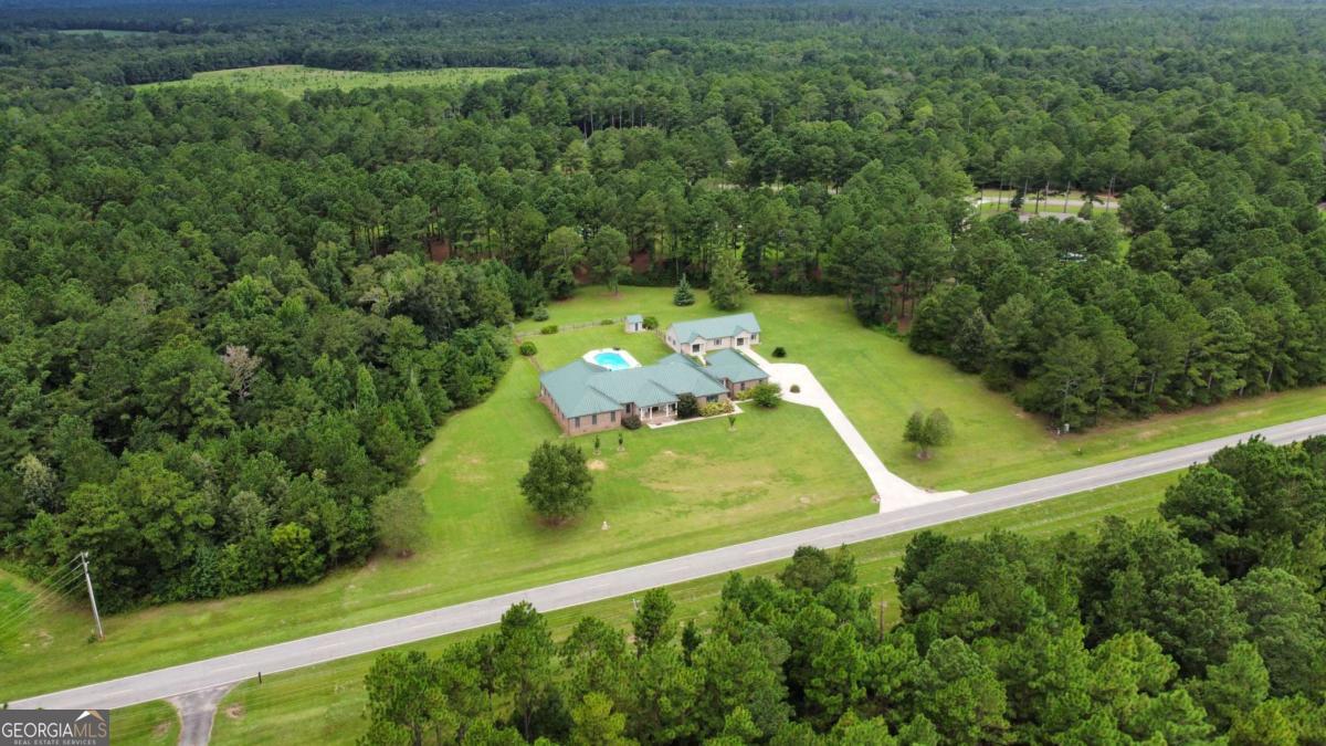 2415 Elko Road Elko, GA 31025 - Photo 71 of 85 an aerial view of a residential houses with outdoor space and trees