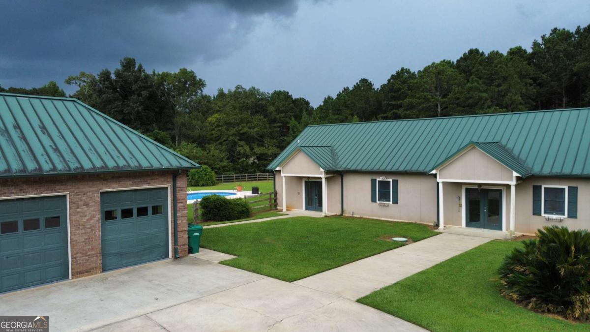 2415 Elko Road Elko, GA 31025 - Photo 76 of 85 a front view of a house with a garden and yard