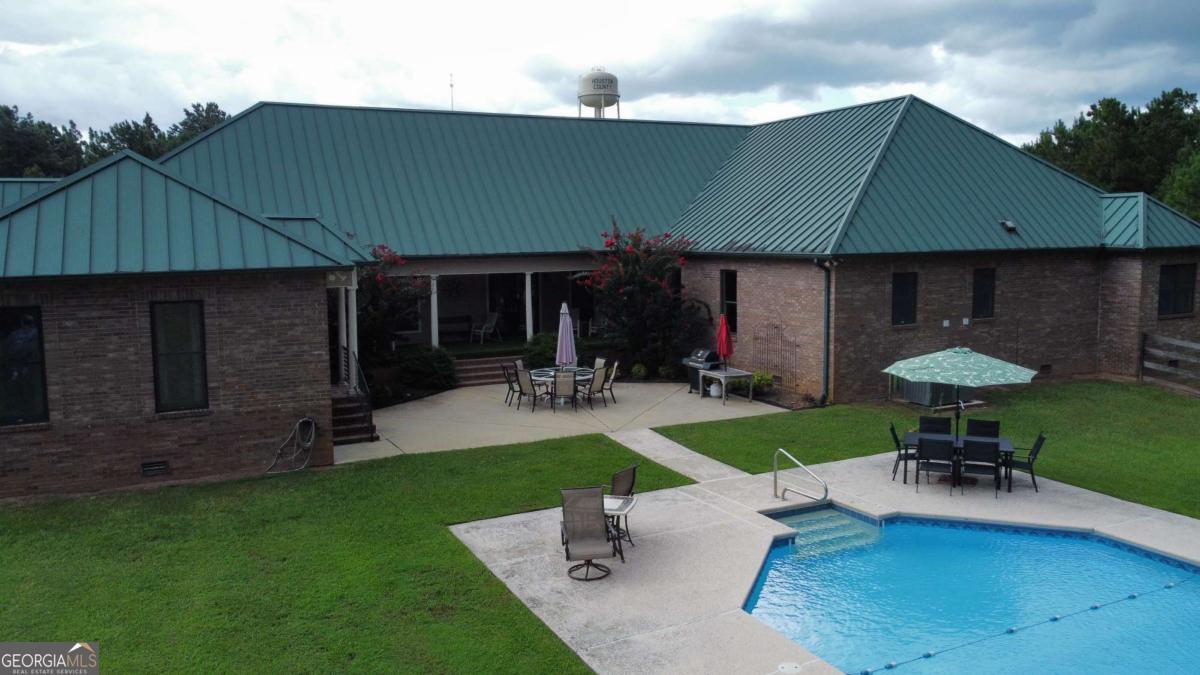2415 Elko Road Elko, GA 31025 - Photo 79 of 85 a view of a backyard with table and chairs under an umbrella
