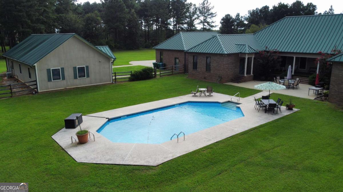 2415 Elko Road Elko, GA 31025 - Photo 81 of 85 a view of a white house with a yard table and chairs