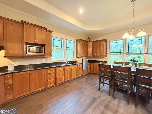 a living room with furniture a flat screen tv and wooden floor