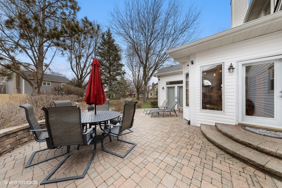1545 Preston Road Naperville, IL 60563 - Photo 37 of 38 a view of a patio with a table and chairs and wooden fence