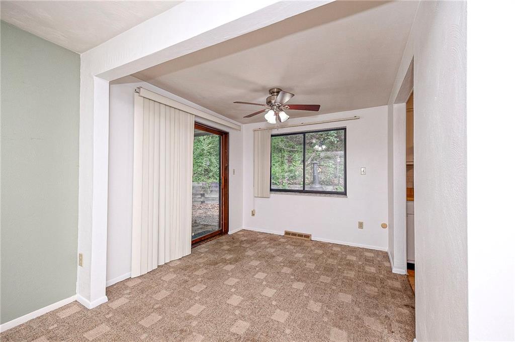 1023 Middle Road Glenshaw, PA 15116 - Photo 15 of 44 Dedicated dining space equipped with a classic ceiling fan and sliding glass doors that open directly to the outdoor patio area.
