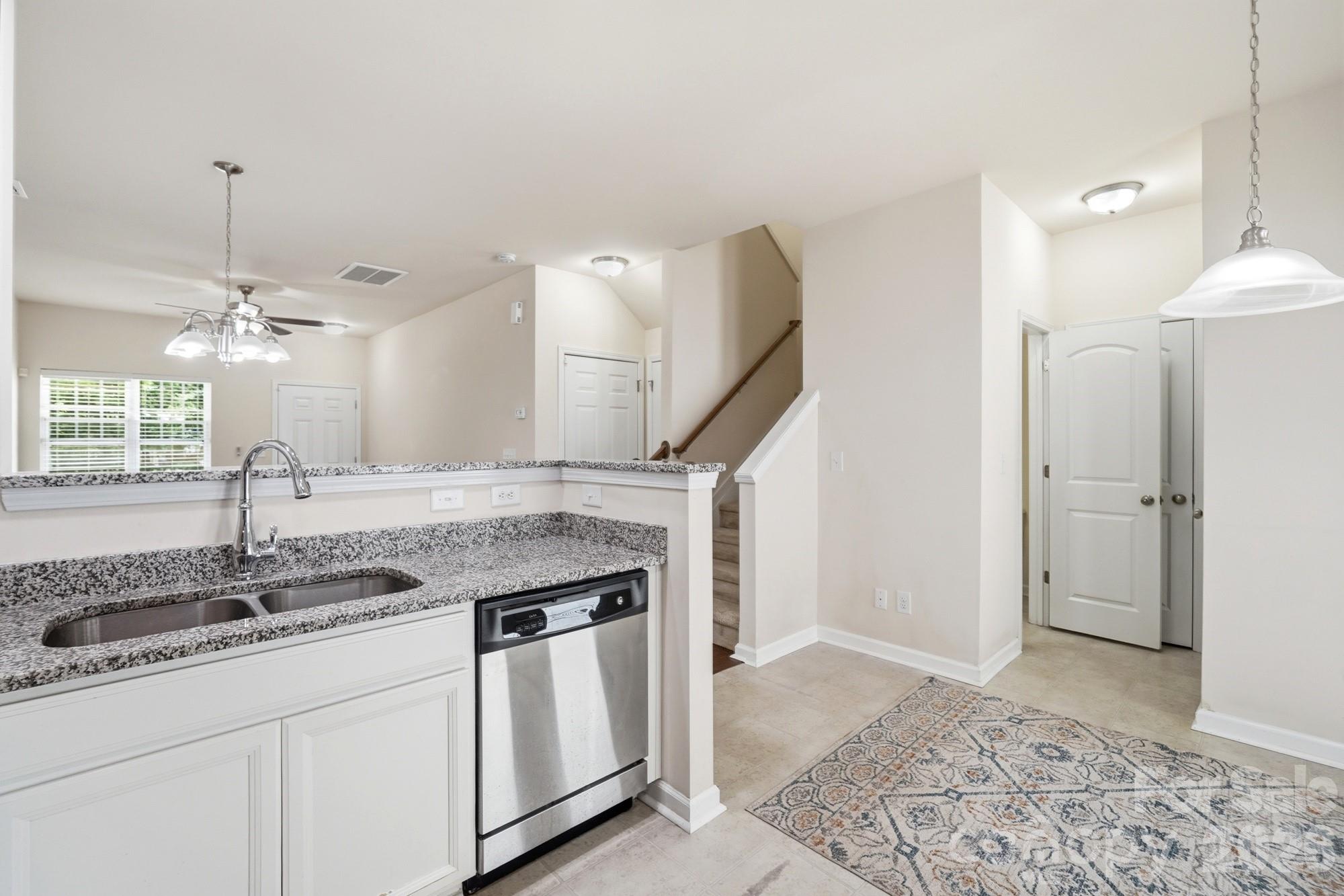 175 Limerick Road, Unit B Mooresville, NC 28115 - Photo 11 of 30 a kitchen with stainless steel appliances granite countertop a sink and a refrigerator