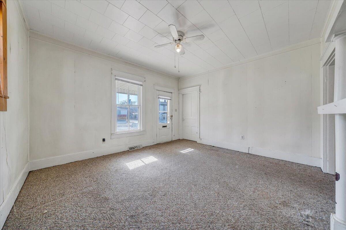 228 East Beech Street Covington, VA 24426 - Photo 4 of 28 an empty room with chandelier fan and windows