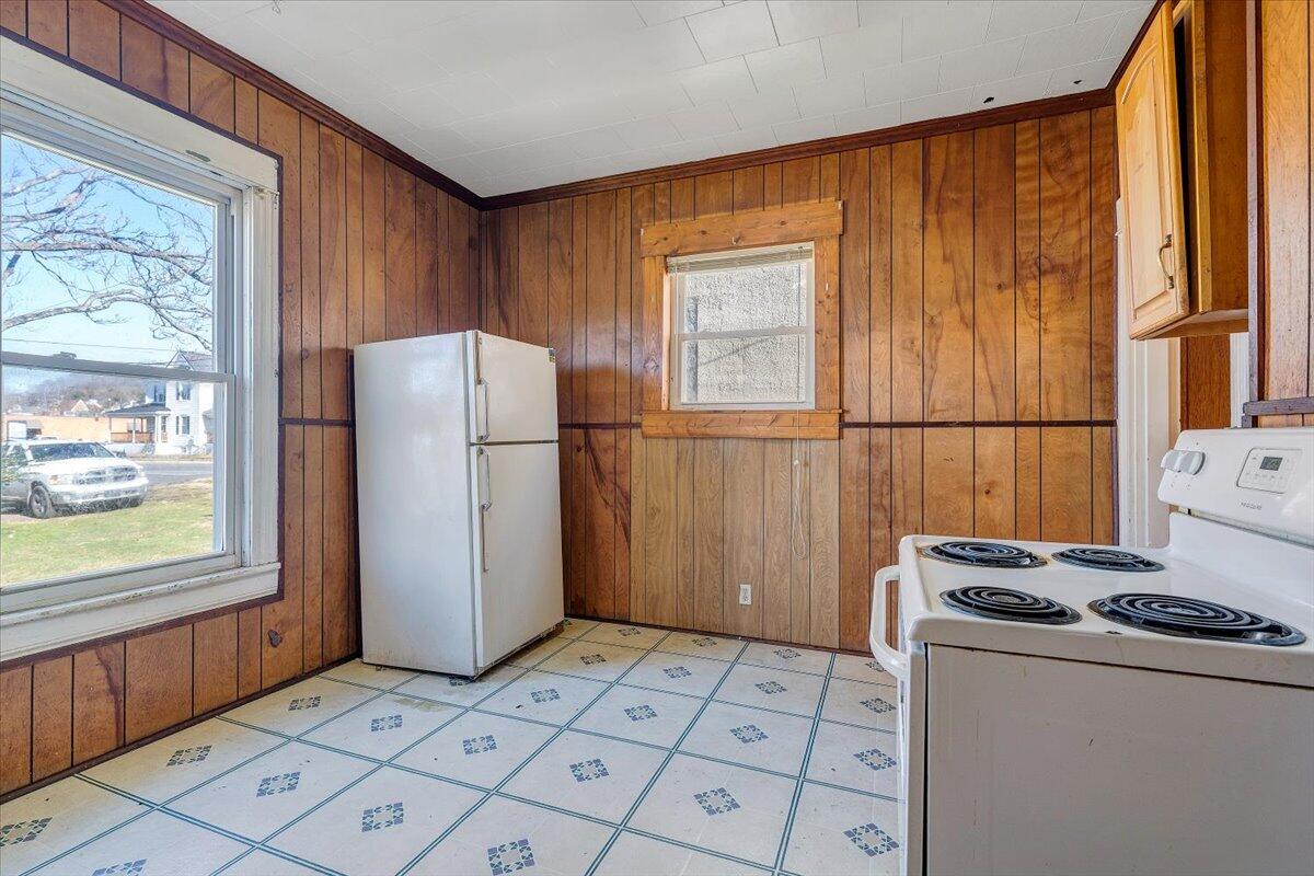 228 East Beech Street Covington, VA 24426 - Photo 10 of 28 a kitchen with a refrigerator and a stove