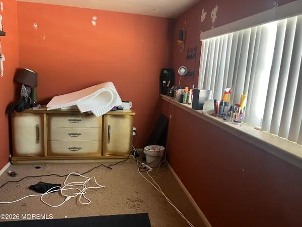 a living room with furniture a flat screen tv and a window