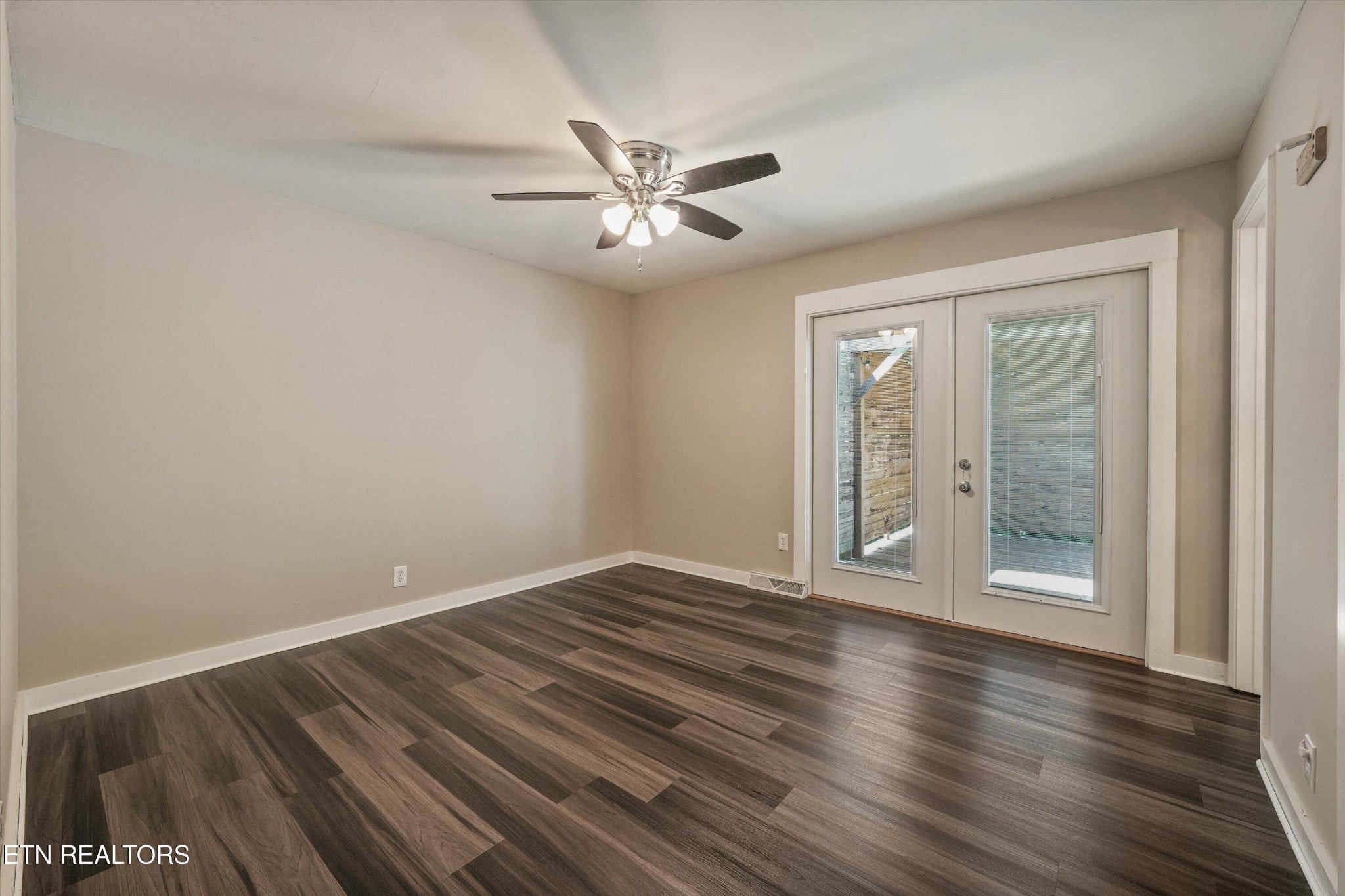 7613 Fall Wind Court Powell, TN 37849 - Photo 20 of 38 a view of an empty room with wooden floor and a ceiling fan