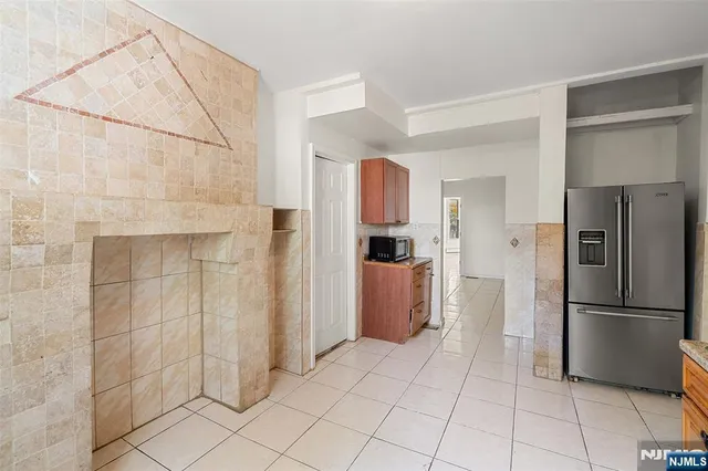 a kitchen with a refrigerator and a refrigerator