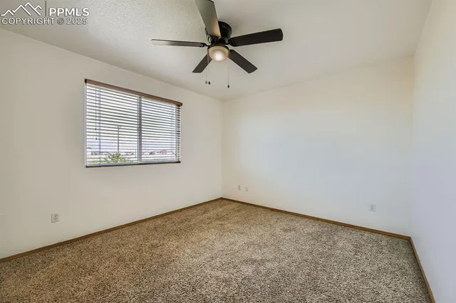 a bedroom with a bed and painting on the wall
