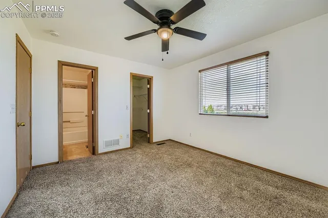 a bedroom with bed and ceiling fan