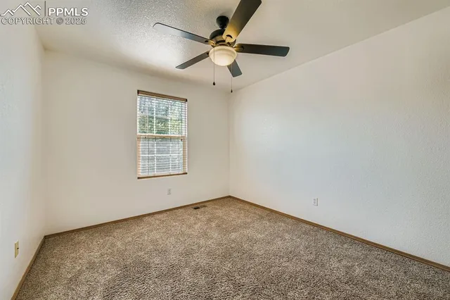 a bedroom with bed and wall painting