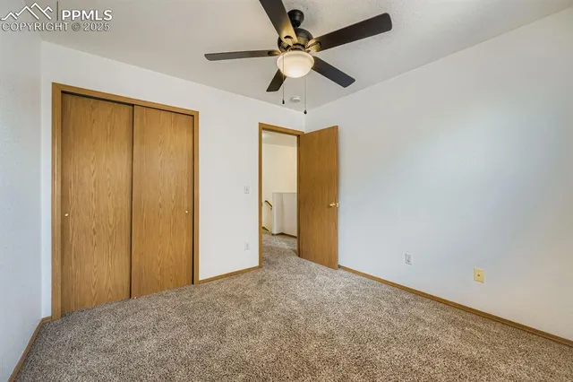 an empty room with fan and a ceiling fan