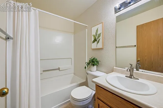 a view of a backyard with a fence and plants