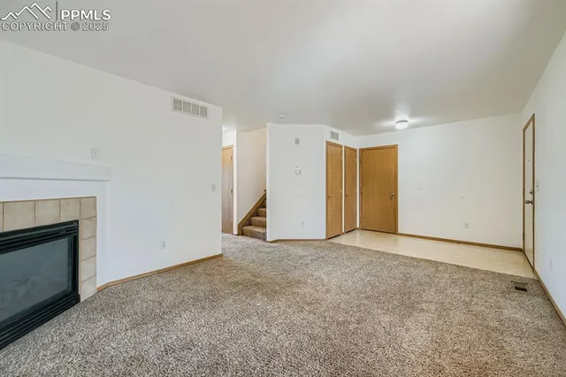 a view of an empty room with a fireplace