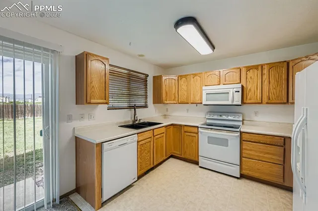 a kitchen with stainless steel appliances granite countertop a stove sink and cabinets