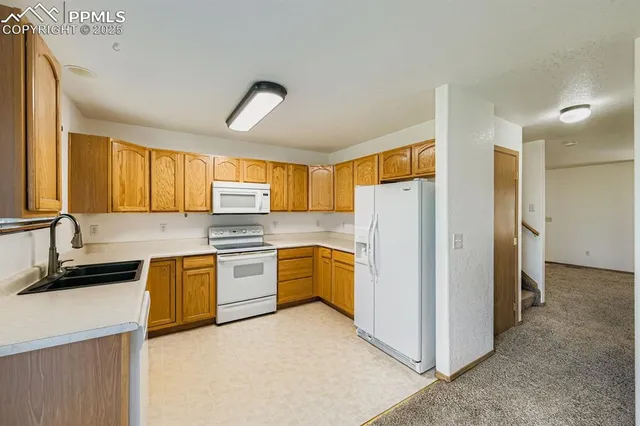 a kitchen with stainless steel appliances granite countertop a sink and a cabinets