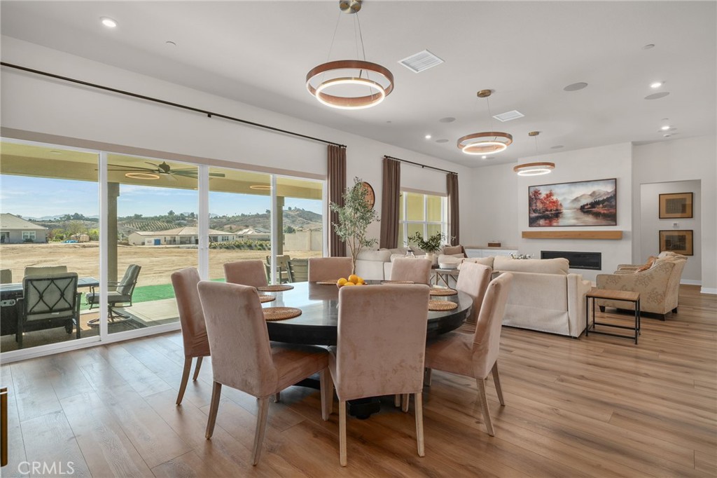 16155 New Canaan Court Riverside, CA 92504 - Photo 14 of 26 a dining room with furniture window and wooden floor