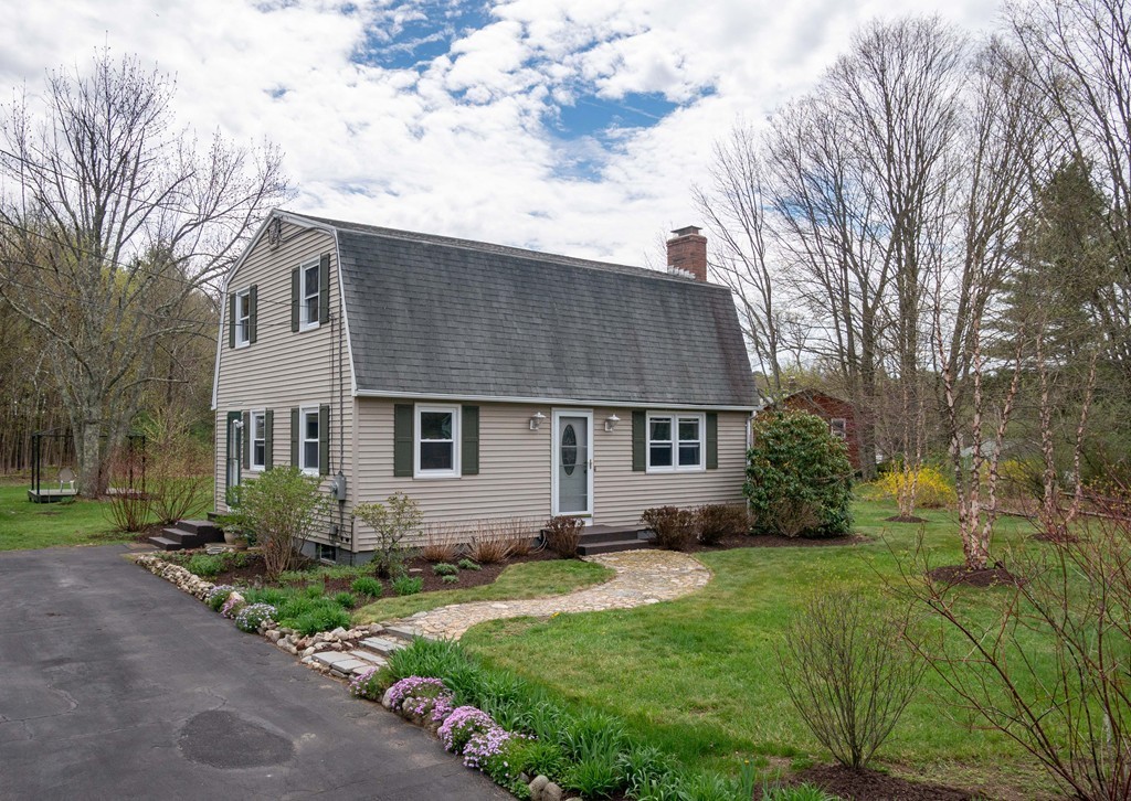 a front view of house with yard and green space