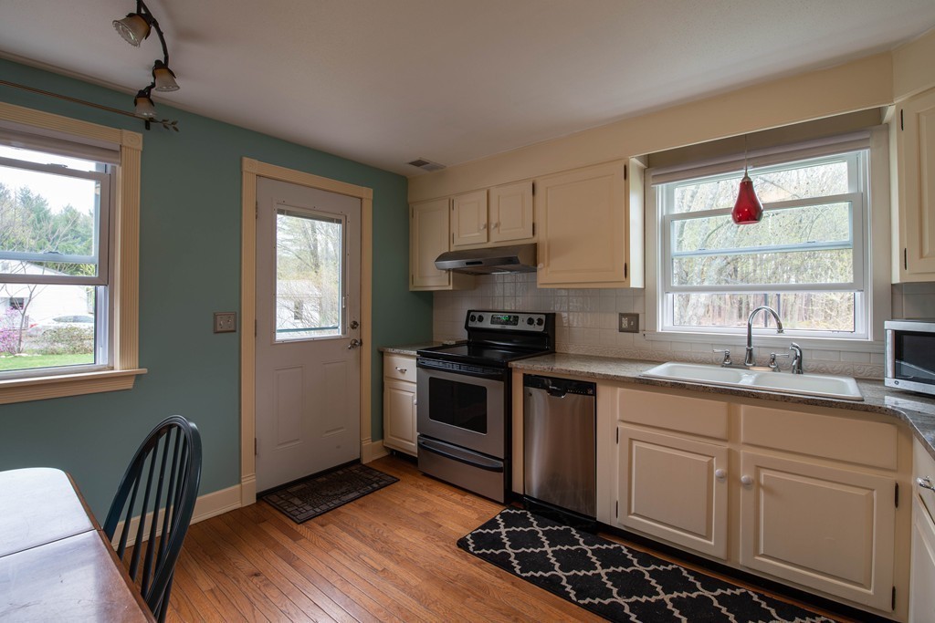 960 Westhampton Road Northampton, MA 01062 - Photo 3 of 16 a kitchen with sink cabinets and window