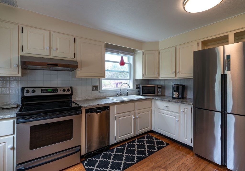 960 Westhampton Road Northampton, MA 01062 - Photo 4 of 16 a kitchen with a refrigerator stove and microwave