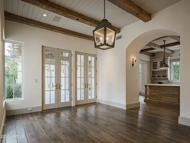 a view of a room with wooden floor window and a ceiling fan