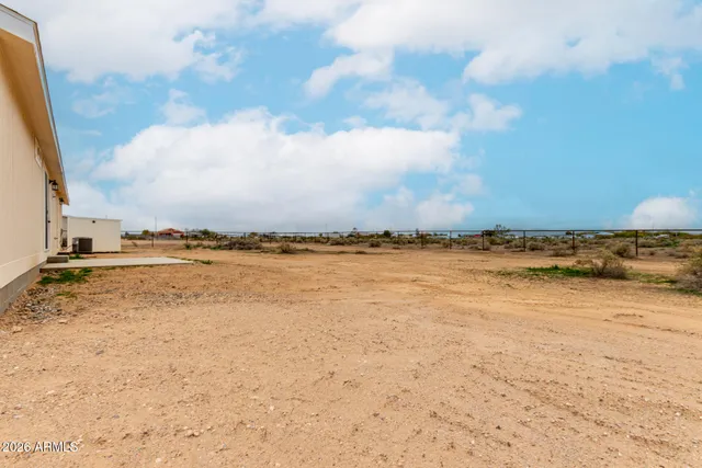 a view of a house with pool and ocean view