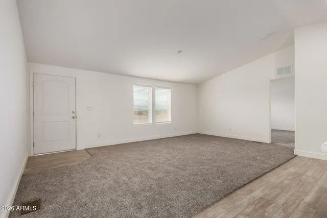 a large kitchen with a refrigerator and a stove top oven