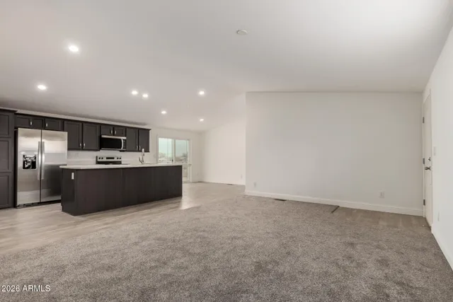 a large kitchen with kitchen island stainless steel appliances a sink and counter space