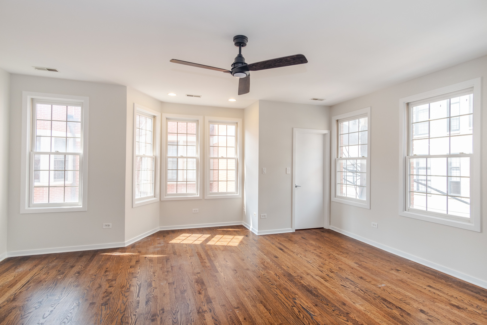 24 North Ada Street, Unit I Chicago, IL 60607 - Photo 13 of 29 a view of empty room with wooden floor and fan