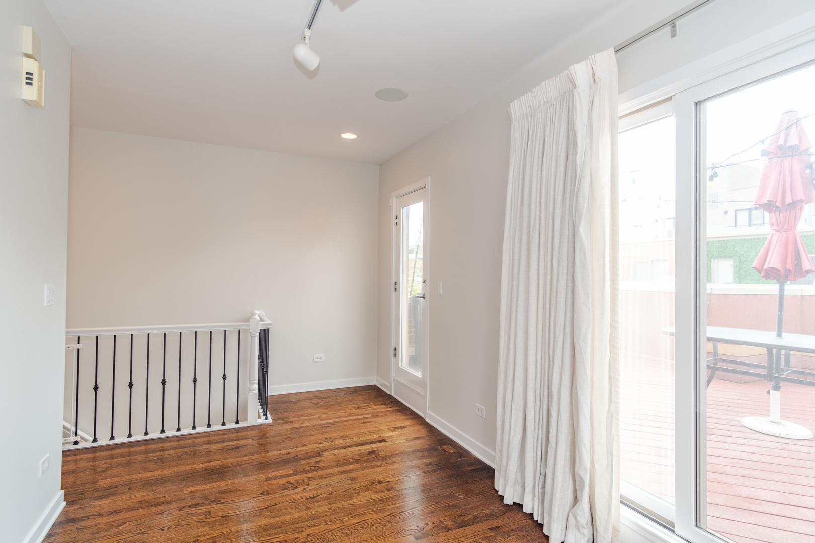24 North Ada Street, Unit I Chicago, IL 60607 - Photo 23 of 29 a view of a hallway with wooden floor and windows