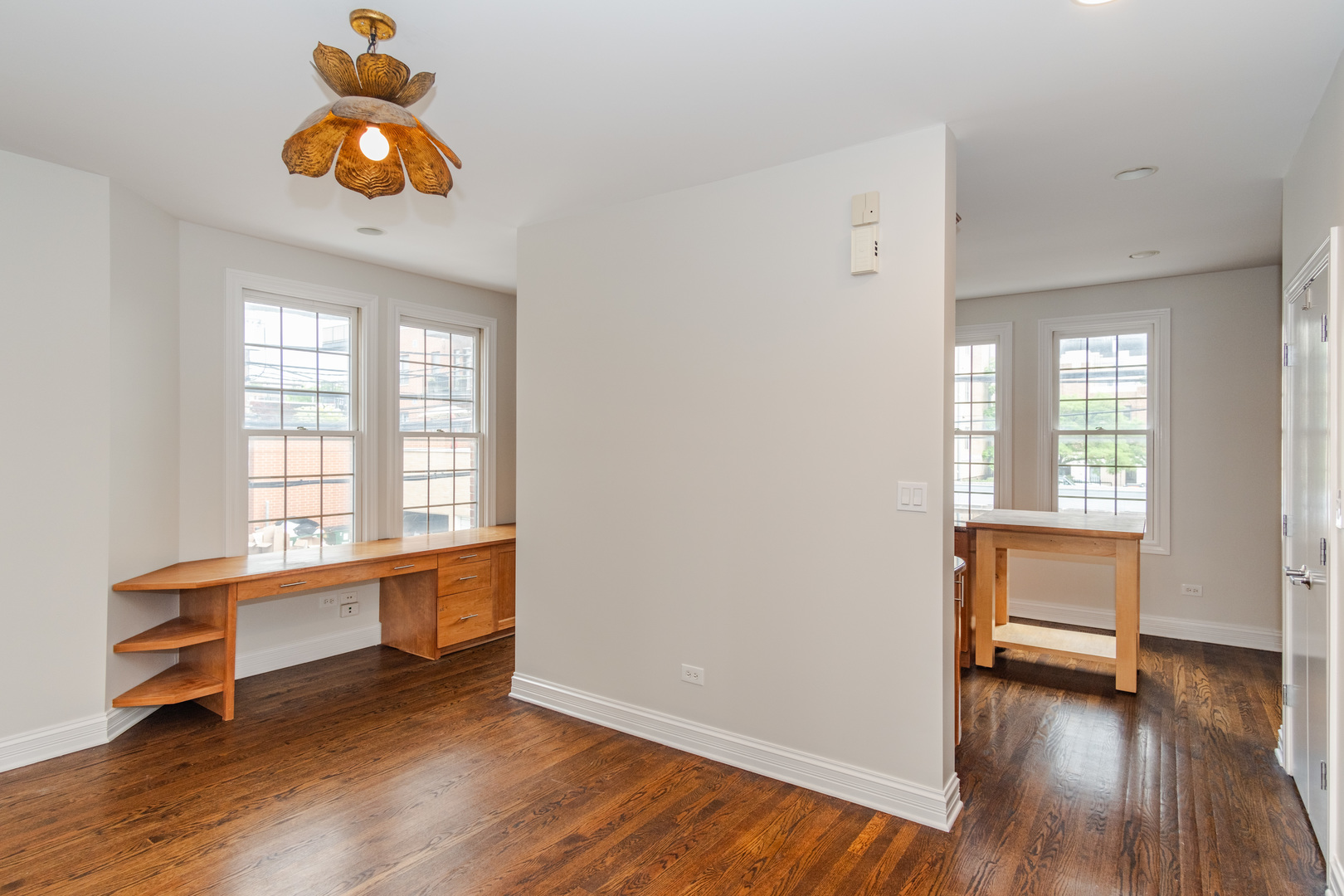 24 North Ada Street, Unit I Chicago, IL 60607 - Photo 7 of 29 an empty room with wooden floor and windows